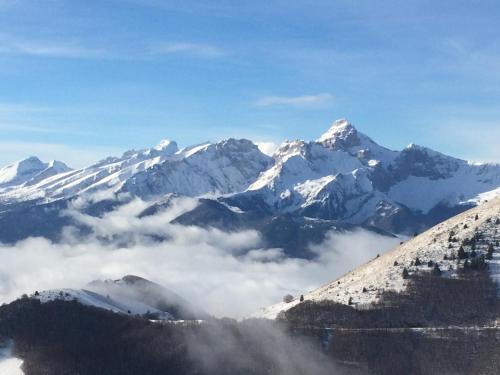 a view of a mountain range with snow covered mountains at Gite le ptit Corpatus in Corps