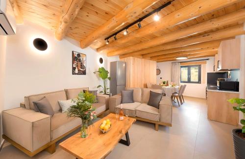 a living room with a couch and a table at Roustico Luxury Villa Heated Whirpool in Rethymno Town