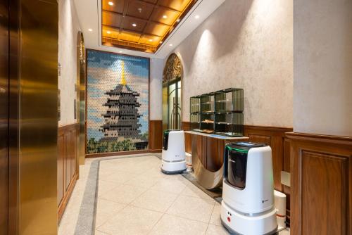 a room with two kettles and a christmas tree on the wall at Nostalgia S Hotel Hangzhou West Lake & Hefang Old Street 时光漫步S酒店杭州西湖湖滨河坊街店 Free fresh ground coffee,Free laundry service in Hangzhou