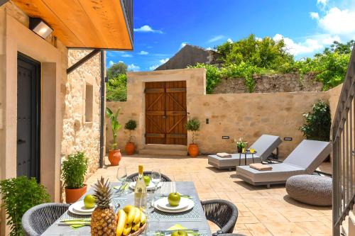 a patio with a table with a pineapple on it at Roustico Luxury Villa Heated Whirpool in Rethymno Town