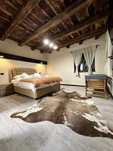 a bedroom with a large bed and a chair at Pensiunea Lorena in Bran
