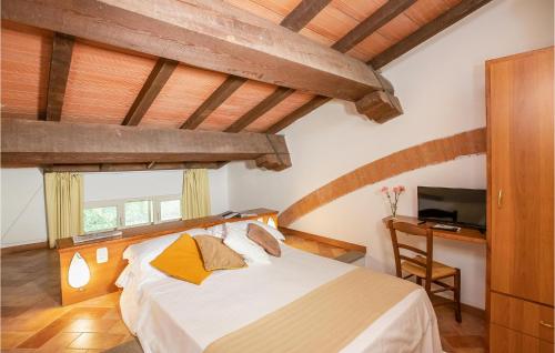 a bedroom with a bed and a desk with a television at Apt A21 in Grosseto