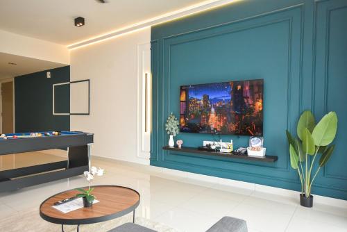 a living room with a blue wall at Midvalley Southkey Mosaic Suite by Nest Home in Johor Bahru