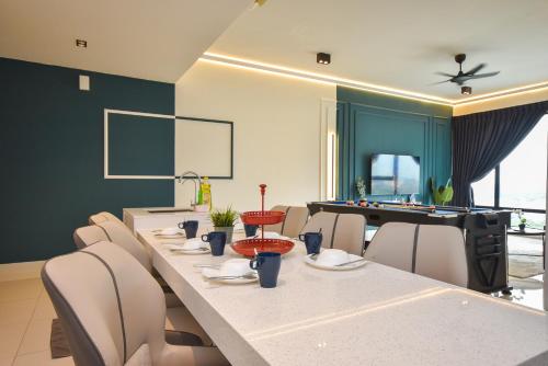 a dining room with a long table with chairs and a pool table at Midvalley Southkey Mosaic Suite by Nest Home in Johor Bahru
