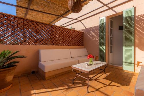 a patio with a couch and a table at Yartan Boutique Hotel - Adults Only in Art&aacute;