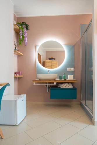 a bathroom with a sink and a mirror at Noi 2 nel Cilento in Agropoli