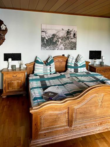 a bedroom with a wooden bed and two night stands at Deine-Eifel-Ferienwohnung in Feusdorf