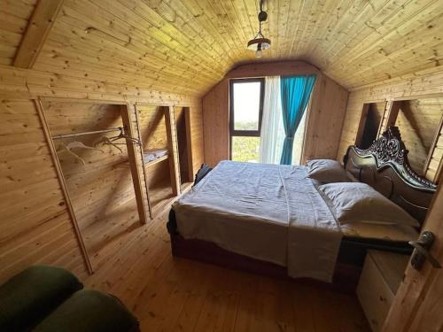 a bedroom with a large bed in a wooden cabin at Have a best time here in Makho