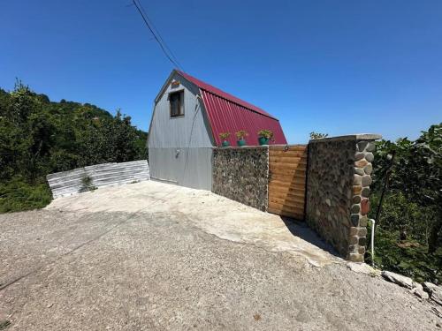 a barn with a red roof on top of a hill at Have a best time here in Makho