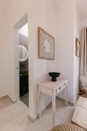 a room with a table and a mirror at Naxian Harmony Town Suites in Naxos Chora