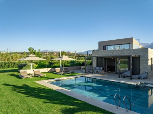 a villa with a swimming pool and a house at Iniada Villas in Chania Town