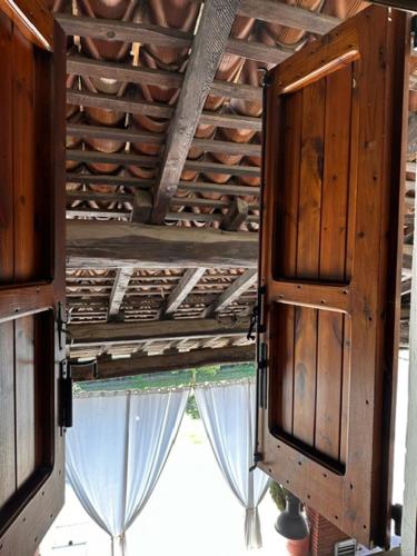 a room with a ceiling with curtains and a window at Casa Vacanza Indipendente Cascina Cremasca with pool in Crema