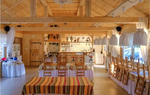a kitchen with tables and chairs in a room at Gorgeous Apartment In Stojcino in Stojcinó
