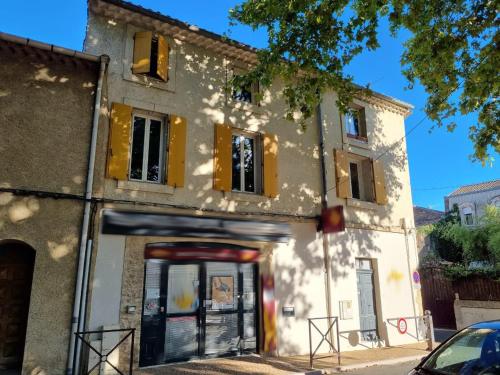 a building with a garage in front of it at LA BELLE ETAPE in Capestang
