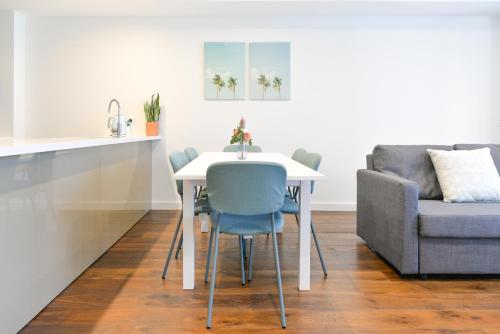 a dining room with a table and a couch at Sydney CBD Modern 2 bedroom Apartment in Sydney