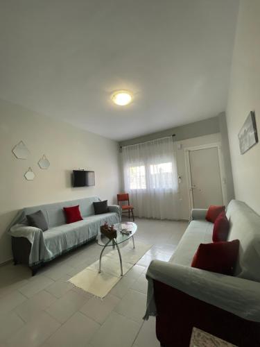a living room with two couches and a table at Nemesis in Litochoro