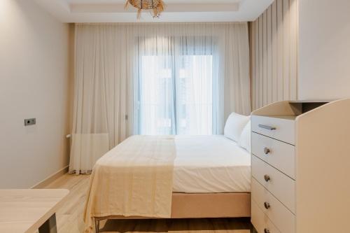 a bedroom with a white bed and a window at Los Suites in Antalya