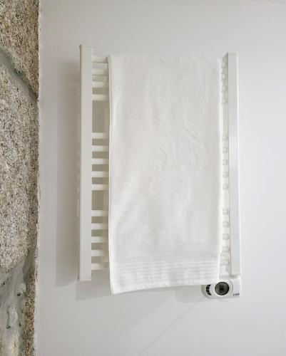 a window with a white towel on a wall at CASA OURO D'ALVA - Luxury Lodging, SPA & WELLNESS in Penalva do Castelo