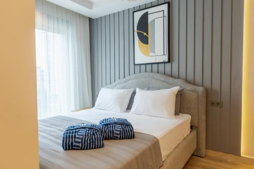 a bedroom with a bed with two pillows on it at Los Suites in Antalya
