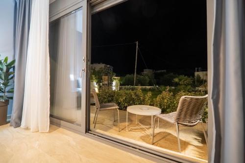 a patio with two chairs and a table on a balcony at Amour Relax Hotel in Almirida
