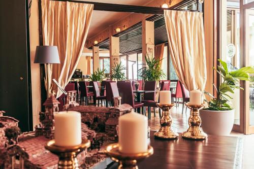 a restaurant with chairs and candles on a table at Hotel Adria & Resort in Toscolano Maderno