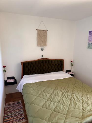 a bedroom with a large bed with a green blanket at Jasna in Poreč