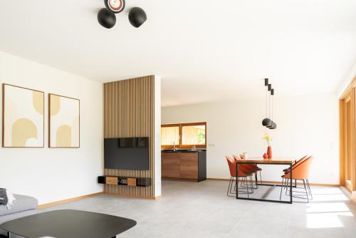 a living room and dining room with a table and chairs at Bergblick Chalet in Bayrischzell
