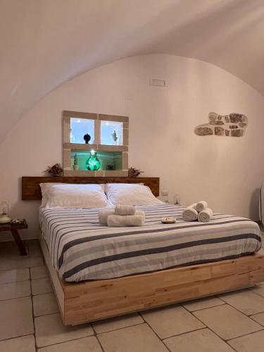 a bedroom with a large bed with towels on it at La Cantina Guest House in Bisceglie