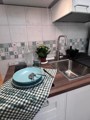a kitchen counter with a plate and a sink at La Cantina Guest House in Bisceglie