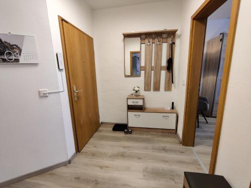 a hallway with a door and a table in a room at Wohlfühl-Wohnungen im Herzen von Clausthal in Clausthal-Zellerfeld