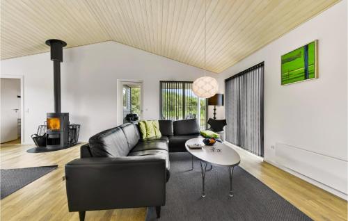 a living room with a couch and a table at Holiday Home Sydmarken Xi in Falen