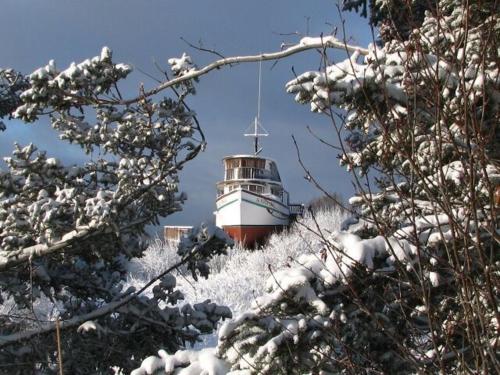 a lighthouse sitting on top of a snow covered hill at Alaska Adventure Cabins in Homer
