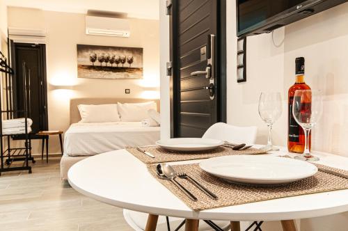 a white dining room with a table and a bed at Boutique apartments Myesis in Samothráki