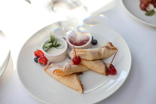 a white plate with food on a table at Pu&scaron;ynė in Bir&scaron;tonas