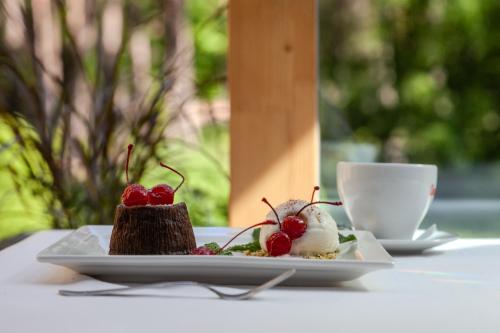 a plate of food on a table with a cup of coffee at Pušynė in Birštonas