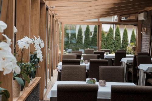 a row of tables and chairs in a restaurant at Pušynė in Birštonas