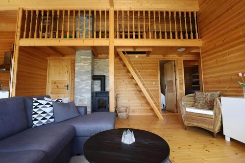 a living room with a couch and a table at Golden Circle Vacation Home with hot tub & fire place in Selfoss
