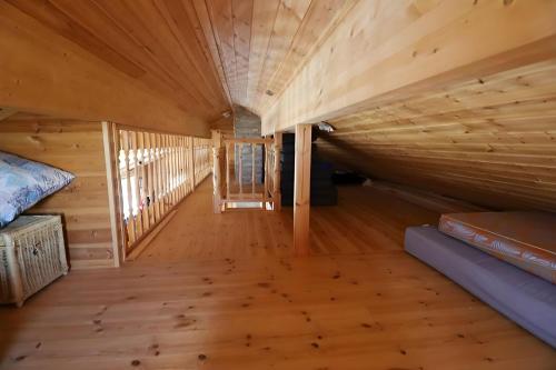 a log cabin with a bed and a wooden floor at Golden Circle Vacation Home with hot tub & fire place in Selfoss