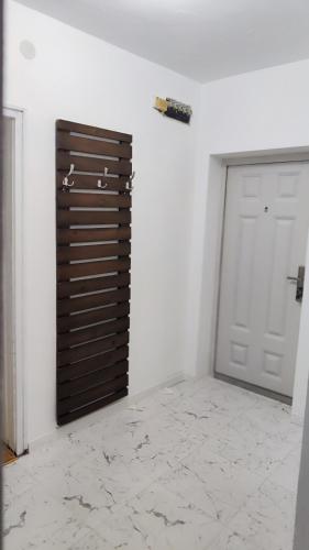 a garage with a metal garage door and a white wall at Calipsso Apartment's in Belogradchik