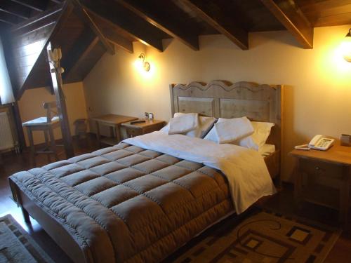 a bedroom with a large bed and a telephone at Guesthouse Filoxenia in Kastoria