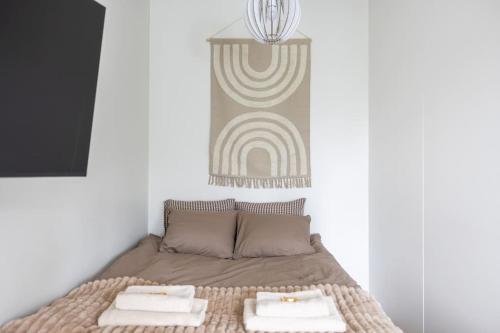 a bedroom with a bed with two towels on it at Nordic Glow Studio in Rovaniemi