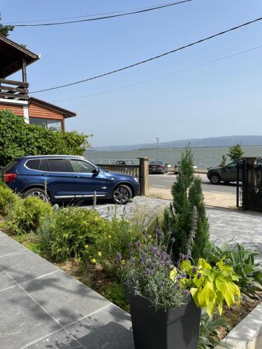 a blue car parked in front of a house at Relax Residence in Golubac