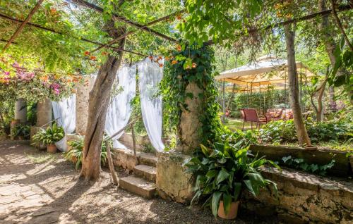 a garden with a pergola with flowers at 4 Bedroom Gorgeous Home In Acquedolci in Acquedolci