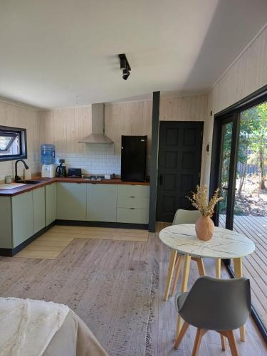 a kitchen with a table and a counter top at Casa Calma in Puerto Varas