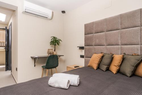 a bedroom with a large bed and a desk at Marina Beach 38 Denia in Denia