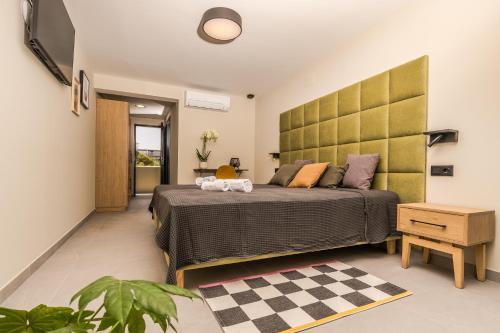 a bedroom with a bed with a large headboard at Marina Beach 38 Denia in Denia