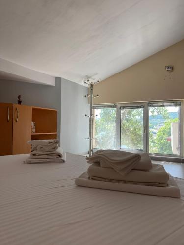 two beds in a room with two windows at TerraMar.Apart in Balchik