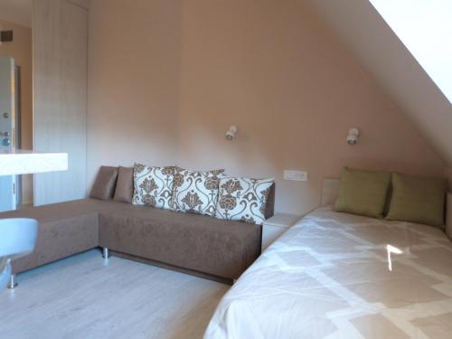 a living room with a couch and a bed at Apartments Sia in Kopaonik