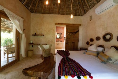a bedroom with a large bed in a room at Casa Mariposa Beach Hotel in Tierra Blanca