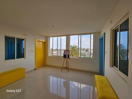 a room with a tripod in a room with windows at Midnight Black By BnBGuys in Orchha